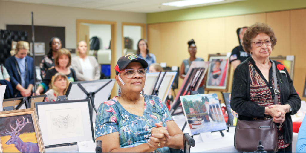 Group of women at an art exhibit, two in foreground.