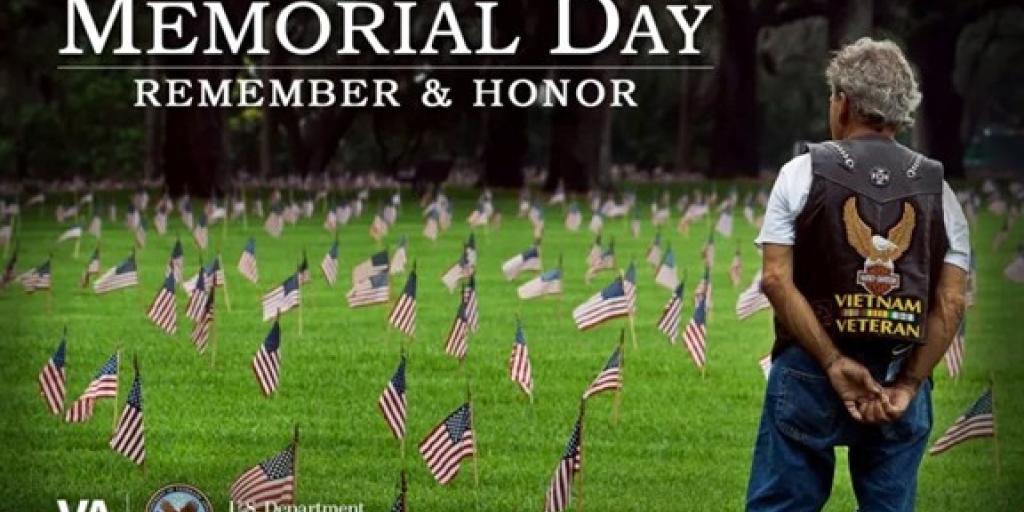 Memorial Day: Remember &amp; Honor. Man stands in field of small flags, text overlay.