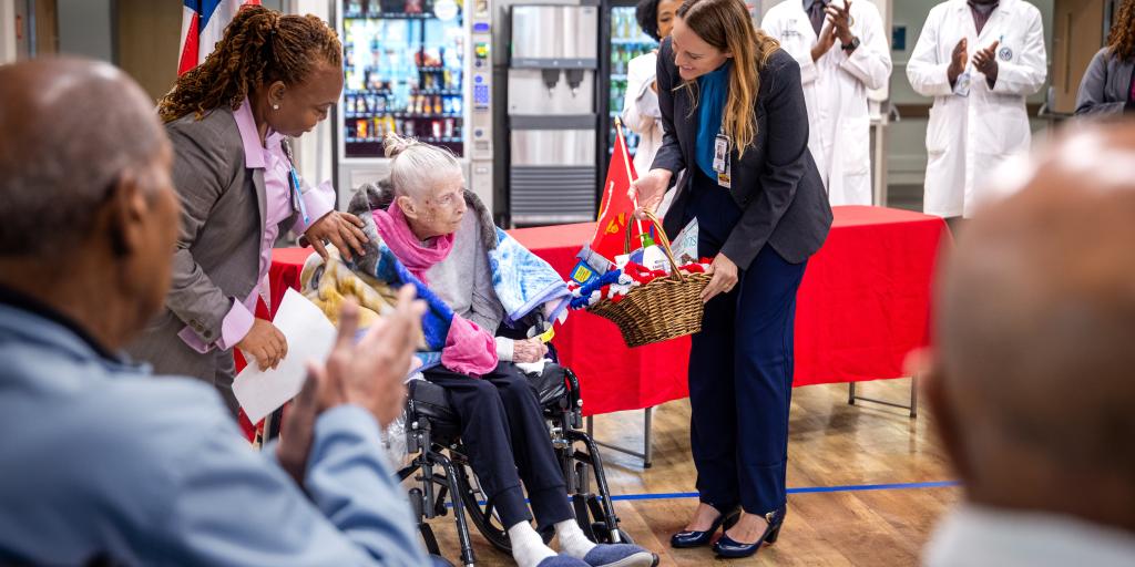 Julia Spence Presents Marine Veteran Jeanette Eno a gift basket in celebration of her service to her country. 
