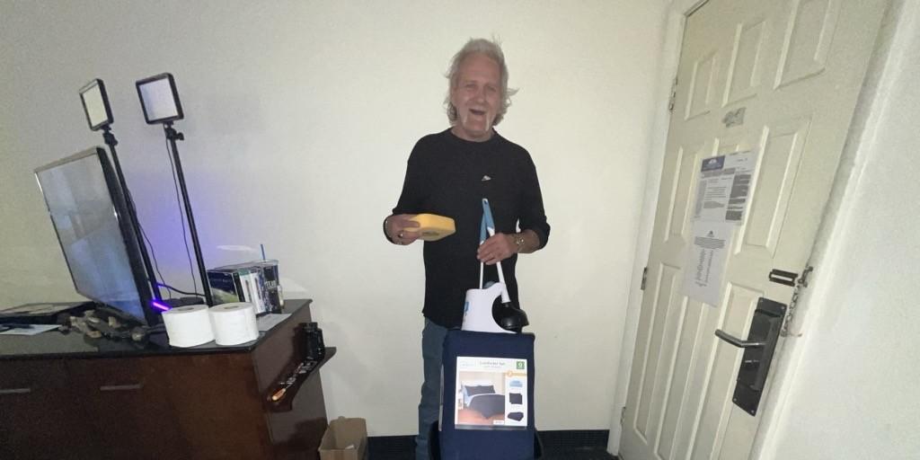 Veteran Ronnie Clark stands in his new home with a move-in kit and other household items.