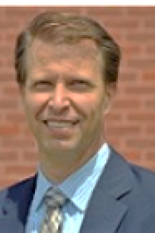 man in front of brick wall