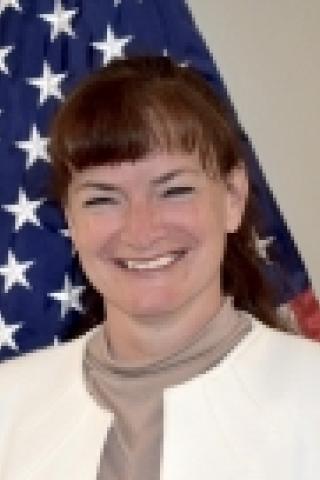 woman in front of American flag