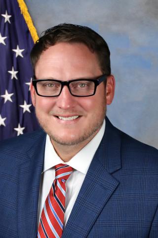 man with glasses and red striped tie.