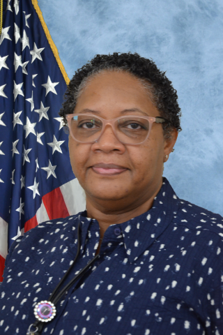 Dr. Ulla Tademy with American flag in background