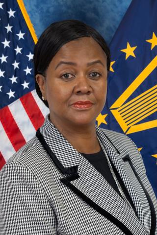 Kimberly Denning portrait with American flag and SES flag behind her.