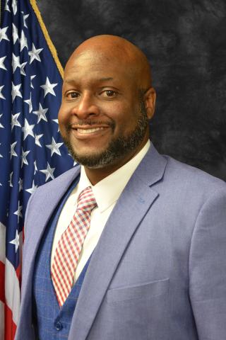 Interim Deputy Director Darren Travis official portrait.