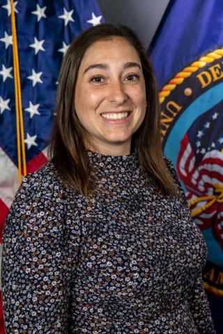 Woman standing in front of flags