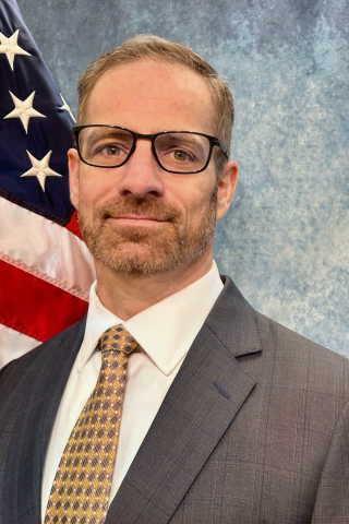 man in front of flag