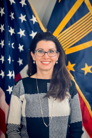 Woman in front of flags