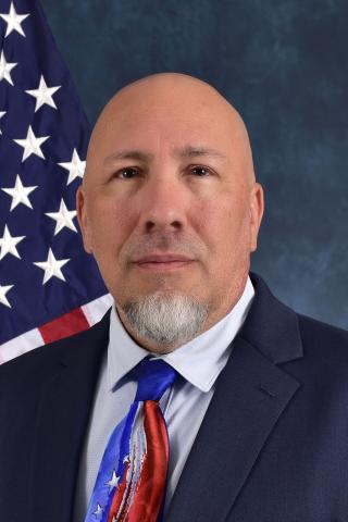 Brian Dyer in front of American Flag