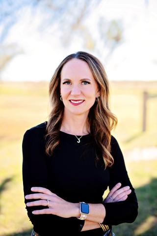Jennifer Bird in a black, long sleeve shirt with her arms crossed.