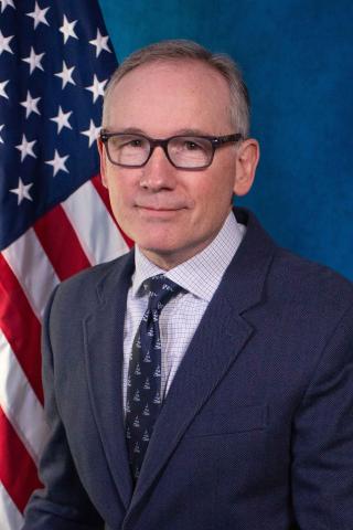 Dr. Nixon's official VA photo with American Flag in background