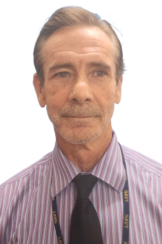 Man in striped shirt and black tie smiling at camera.