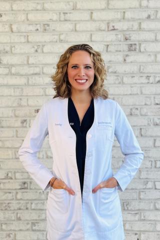 Woman in lab coat smiling