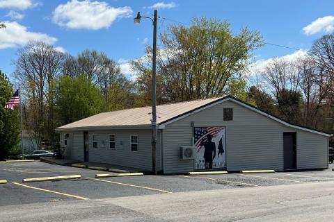 Sign labeled Russell County Honor Guard with silhouette of a saluting soldier.
