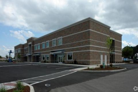 Exterior view of the Salem Vet Center. Brown, multi-story brick building with glass front entrance doors.