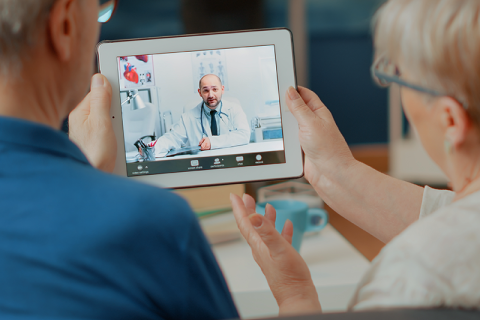 Veteran and Caregiver on a virtual clinic visit call with a doctor