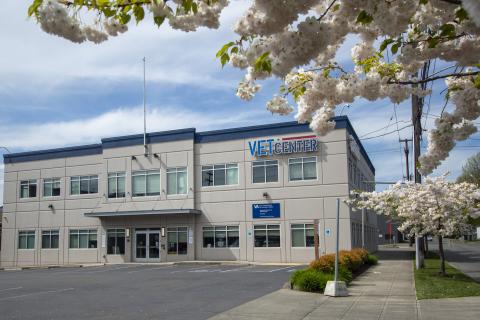 Front view of Building with Seattle Vet Center sign prominently displayed on side of building. Doors in middle of building are the front entrance.