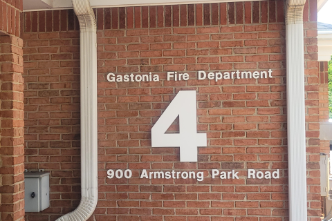 Brick wall corner of the Gastonia Fire Department #4 with the address 900 Armstrong Park Road written on it.
