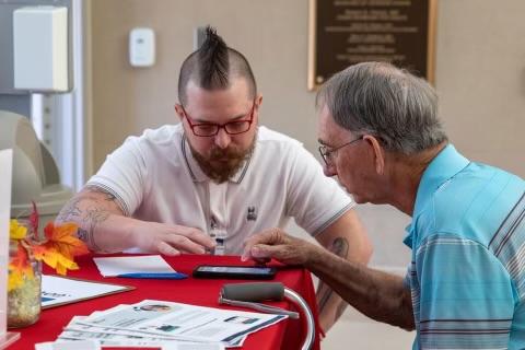 VA staff member working with a Veteran to create a secure, identity-verified account to sign in to manage VA benefits and care online.