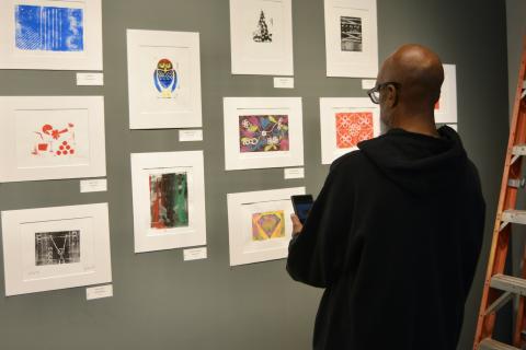 Thomas Pemberton, a Navy Veteran proudly photographs his prints 