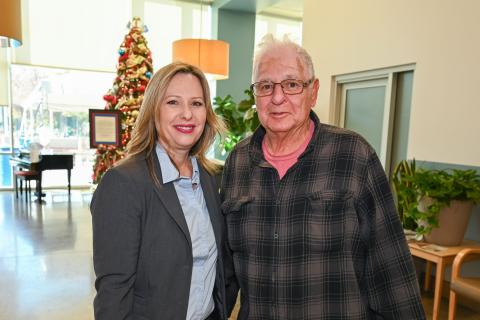 Nurse Lola smiles for a photo with a Veteran at VA Loma Linda