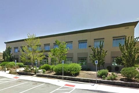 Two story building. Entrance is located near the flagpole. 