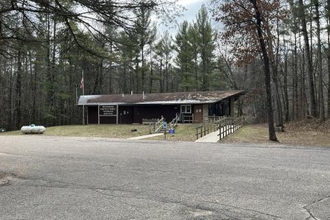 Driving into the parking lot you will see a small building in the woods with a wheelchair ramp.  With a Menominee County / Tribal VSO sign in front.