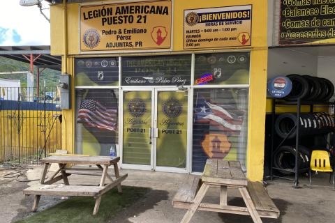 Yellow building with double door entrance on left hand side. American Legion signage posted over double door entrance.