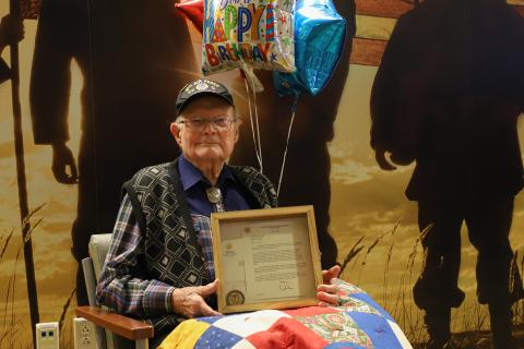 a 100 year old world war 2 Veteran receiving a Centenarian Recognition Award