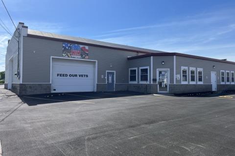 one story light gray building with white trim