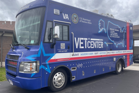 large blue vehicle wrapped with Vet Center branding 