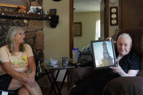 Ron Gasper recalls the memories of his time at the Rock of Ages Lighthouse while his daughter Sue looks on. 