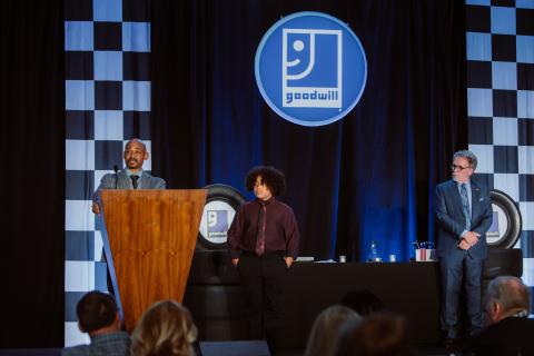 Marcus and his son on stage accepting award.