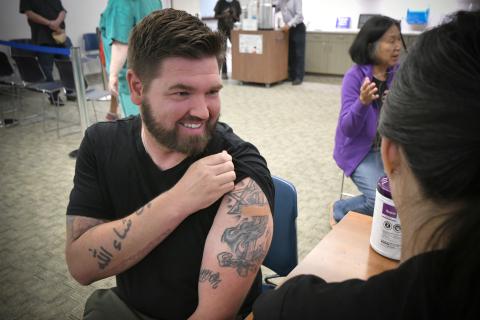 Flu Clinic Veteran Male Smiling getting the Flu vaccine.