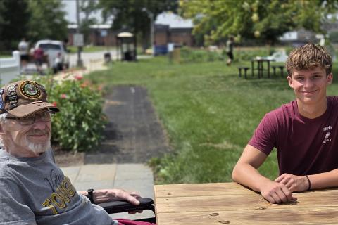 Haden Toenjes and his grandfather enjoy the Hines Community Living Garden. 
