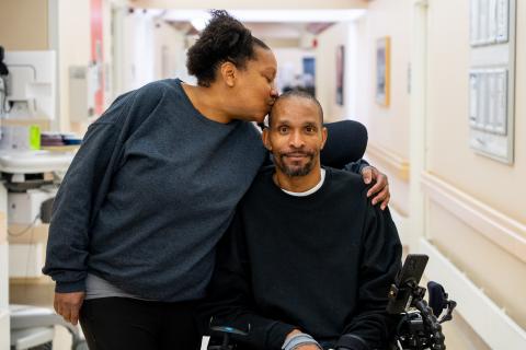 Crystal Jackson kisses her brother on the head