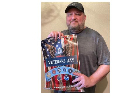 Veteran Jeremy Carpenter holding his winning poster