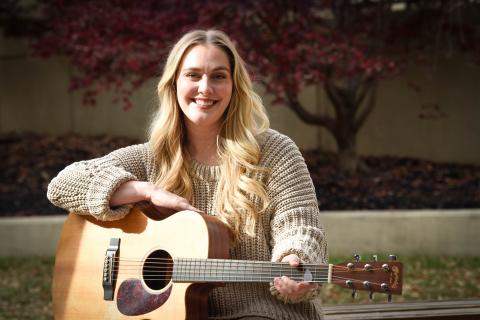 VHSO social worker holding her guitar