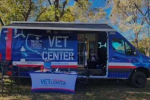Blue van with red and white details including the Vet Center logo