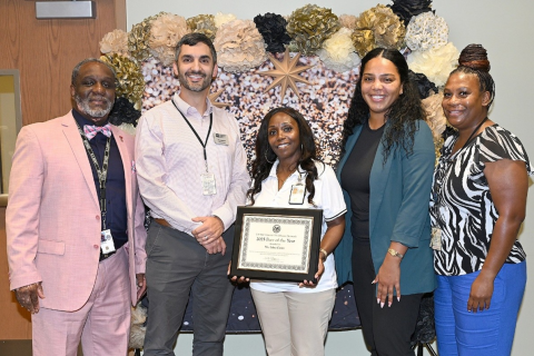 Edna J. Curry poses for a group photo with colleagues after receiving her award.