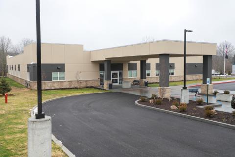 Outpatient clinic entrance with covered drive-up drop off entrance area and pillars