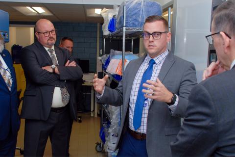 Group of men in suits and ties having a discussion.