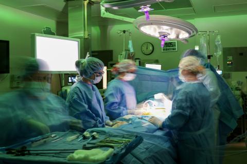 surgeons in an operating room performing surgery.