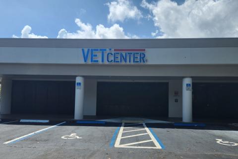 Vet Center building with large sign, two pillars, and parking lot.
