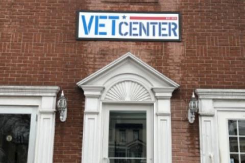 Vet Center sign above brick building entrance with white trim and glass door.