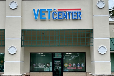 Vet Center storefront with green plants in front.
