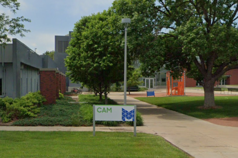 View of the front of the CAM building from the parking area.