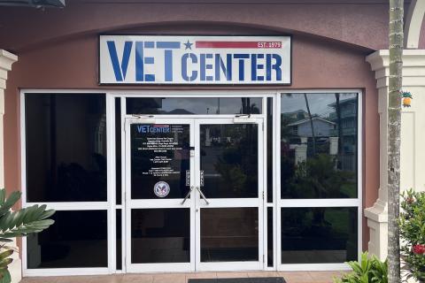 Vet Center sign above double glass doors with black mat in front.