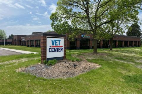 Vet Center sign in front of building with green lawn and tree.